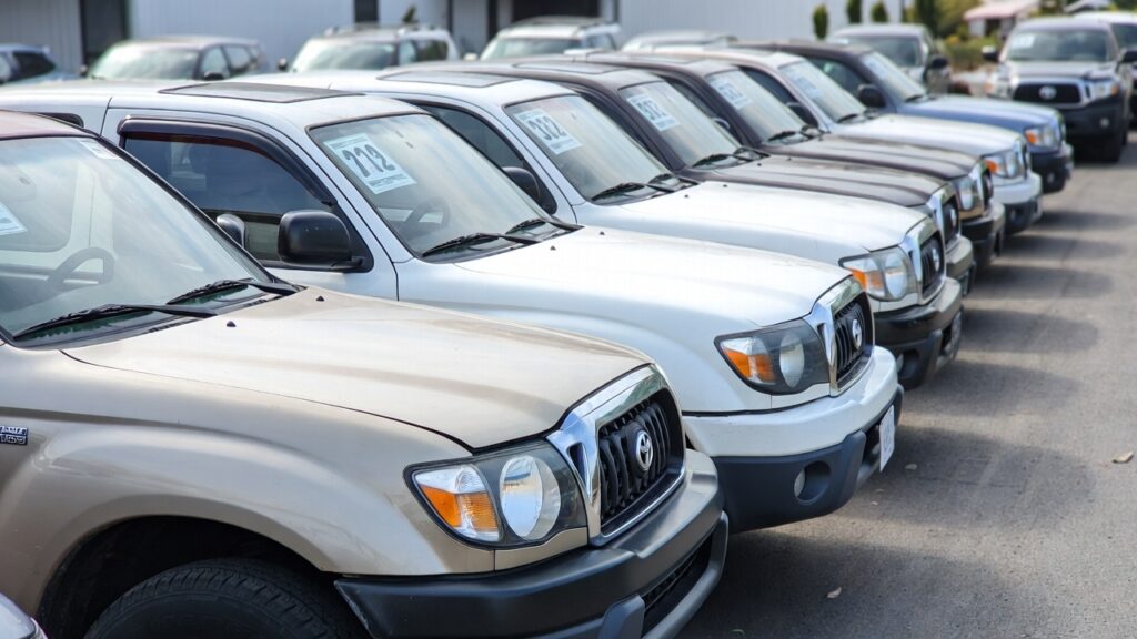 03 Toyota Tacoma lineup at used vehicle lot showing current prices and value