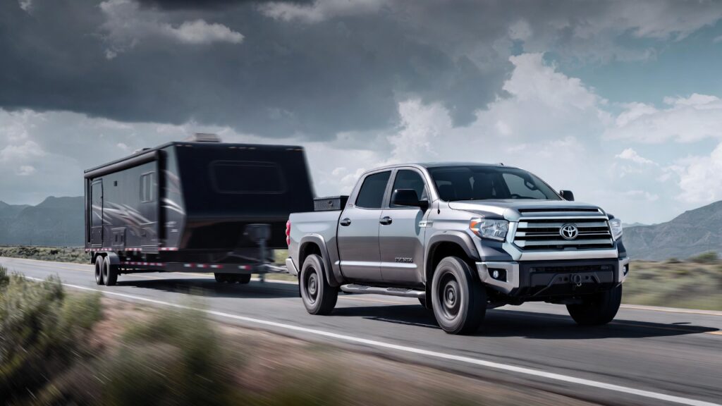 2014 Toyota Tundra towing heavy trailer on open road