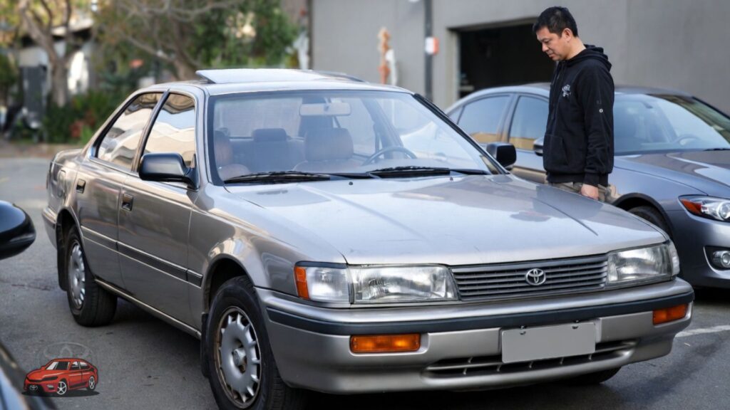 Is the 1991 Toyota Camry worth buying today image showing buyer inspecting old reliable sedan before purchase