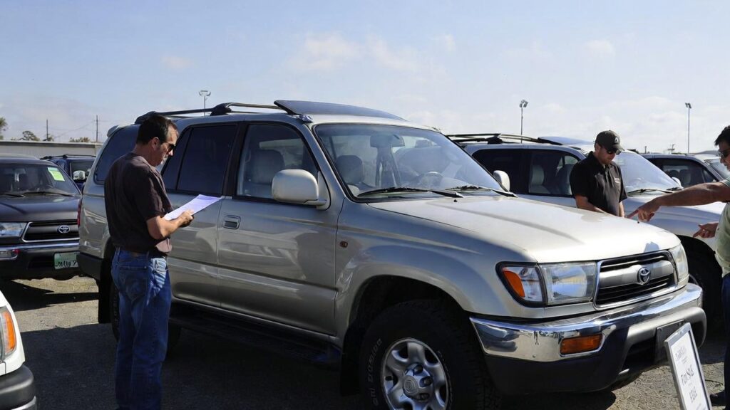 Buyer inspecting a 1997 Toyota 4Runner for sale